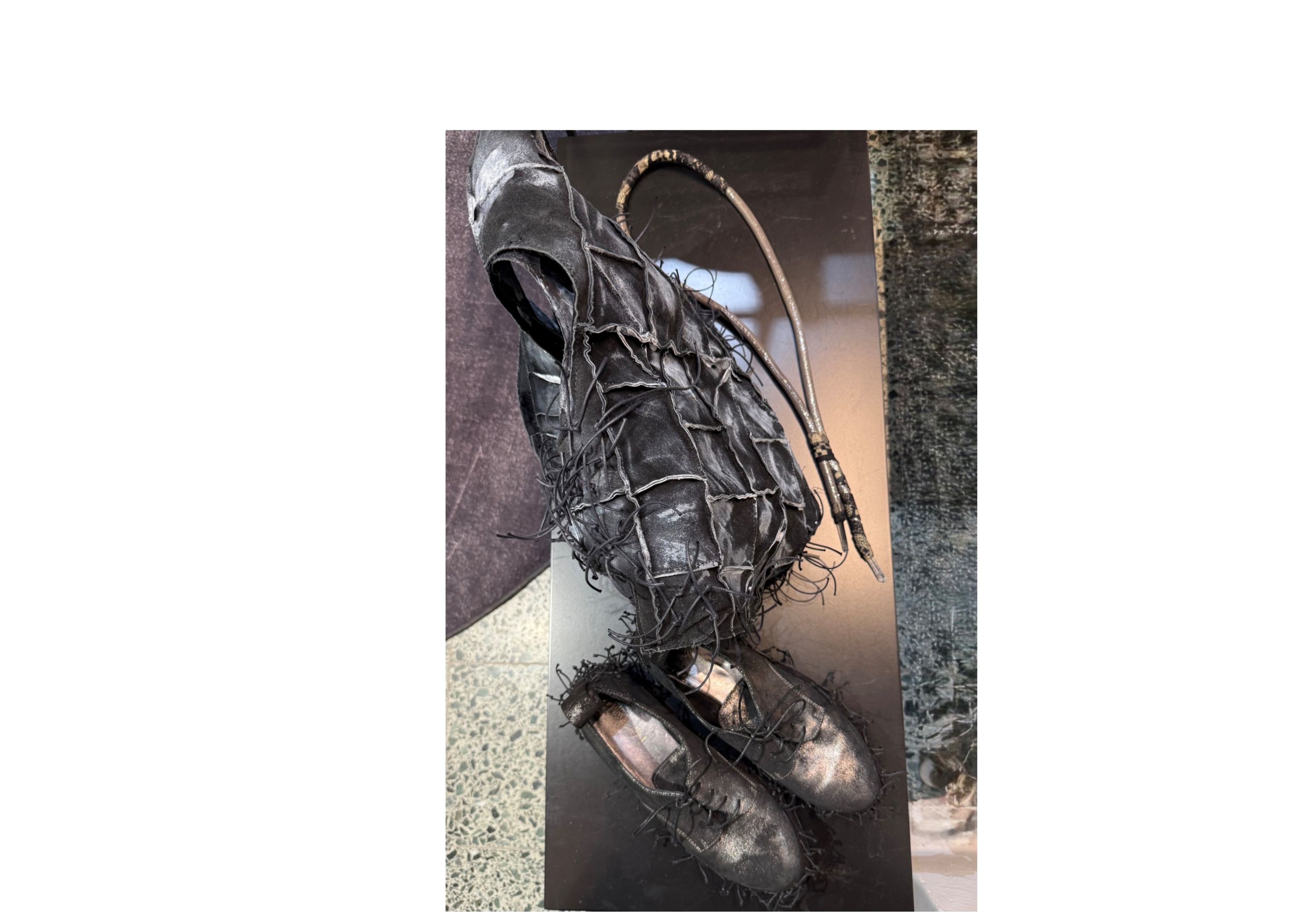 two wearable art objects made from upcycling materials